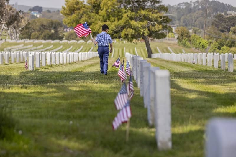 Young Boy Placing Flags on Veterans Grave-cm